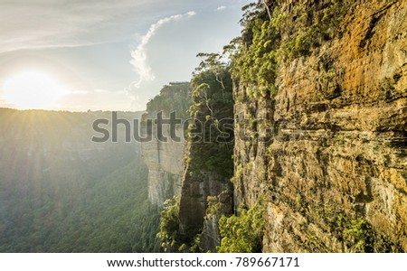 Rugged rock formation along cliff face at Katoomba, Blue Mountains National Park, a UNESCO World Heritage site. Distant viewing platform is Echo Point.