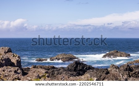 Rugged Rocks on a rocky shore on the West Coast of Pacific Ocean. Summer Morning Sky. Ucluelet, Vancouver Island, British Columbia, Canada. Nature Background