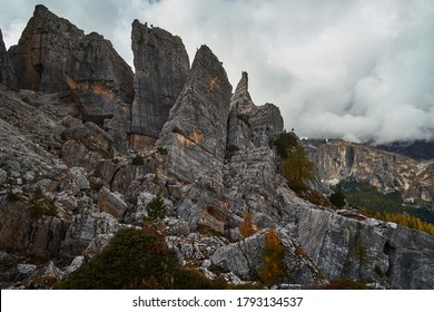 Rugged and rocky alpine mountain ranges with cloudy blue sky above in The Dolomites. These iconic mountain peaks are located at Cinque Torri in the Tyrol region of Italy. - Powered by Shutterstock