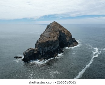 A rugged sea stack rises from the Pacific Ocean off the coast of northern Oregon. Impressive sea stacks are found up and down the west coast from California to Washington.