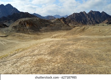 Rugged Terrain And Scenic View Of Mountain Ranges.