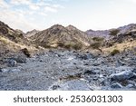 The rugged terrain of the United Arab Emirates showcases dramatic mountains and rocky landscapes. Gravel roads and wadis.