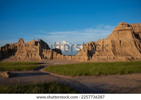 The rugged terrian of the Badlands National Park in South Dakota, photographed with cumulus clouds during a summer afternoon. 