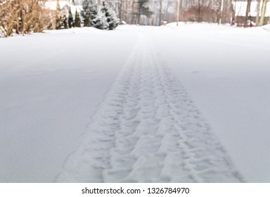 Rugged Tire Track In Freshly Fallen Snow On A Rural Street