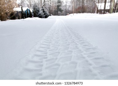 Rugged Tire Track In Freshly Fallen Snow On A Rural Street