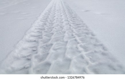 Rugged Tire Track In Freshly Fallen Snow On A Rural Street