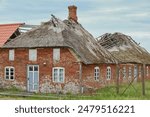 Ruined abandoned house with thatched roof in Sondervig Denmark