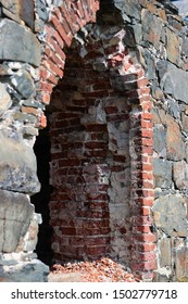 Ruined brick arch. Broken arch in a stone brick building.