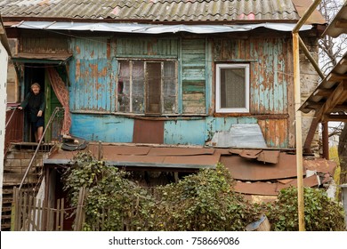 Ruined Houses In Poor Neighborhood For Poor People. Without Major Repairs, Old Houses Are Destroyed During A Crisis. Architecture Of The District. Old  House For The Poor