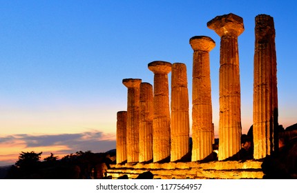Ruined Temple of Heracles columns in famous ancient Valley of Temples on blue hour sunset in summer evening, Agrigento, Sicily, Italy. UNESCO World Heritage Site.