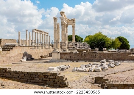 The ruined Temple of Trajan in Pergamon Ancient City. Corinthian order stone-cut relief on the frieze. Dramatic sky at background. History, art or architecture concept. Bergama, Turkey