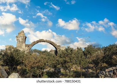 Ruins of an ancient building in a long forgotten city in northwestern Turkey under blue skies with fluffy white clouds