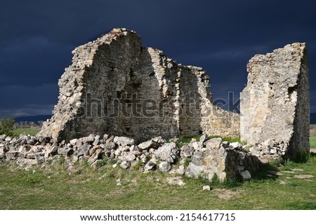 Ruins of an ancient medieval church in Tök, Hungary. There is the stormy sky in the background.