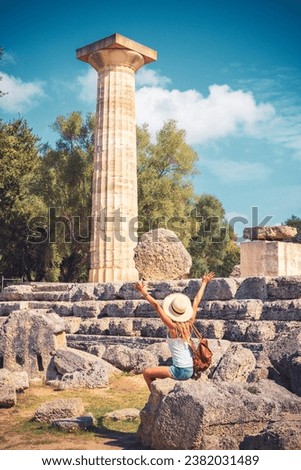 Ruins in Ancient Olympia, Peloponnese, Greece- Woman tourist enjoying famous Greek site