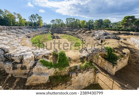 Ruins of ancient Roman amphitheater with typical Colosseum oval shape in Ortigia, an island in Syracuse, Sicily, Italy