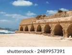 Ruins of an ancient Roman aqueduct in Caesarea National Park. Israel