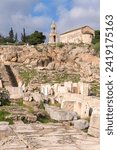 Ruins of ancient sanctuary at Elefsina. Greek orthodox Church of Panaghia Mesosporitissa with bell tower at background. Cover page. Eleusis, Attica, Greece