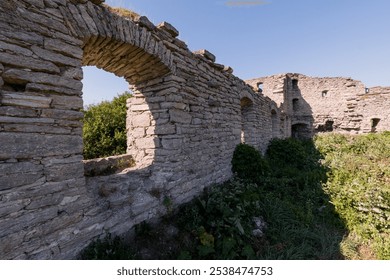 Ruins of an Ancient Stone Structure Surrounded by Lush Greenery. - Powered by Shutterstock