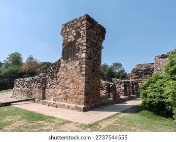 Ruins of an ancient stone structure within the Qutab Minar complex