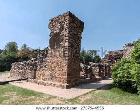 Ruins of an ancient stone structure within the Qutab Minar complex