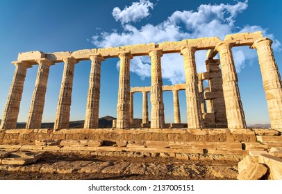 Ruins of an ancient temple of Poseidon at Greece Cape Sounio. Poseidon is the Greek god of the sea. Shot of temple ruins on sunset. Tourist landmark of Attica, Sounion, Greece.