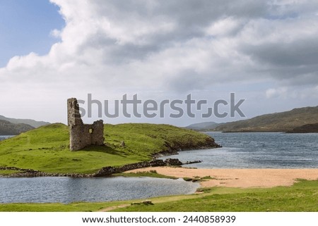 Ruins of Ardvreck Castle rise on a grassy peninsula, caressed by the waters of Loch Assynt in the Highland Council area, under the vast Scottish sky