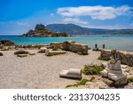 Ruins of the Basilica St. Stefanos in front of beautiful Island Kastri - beautiful coast scenery of Kos, Greece