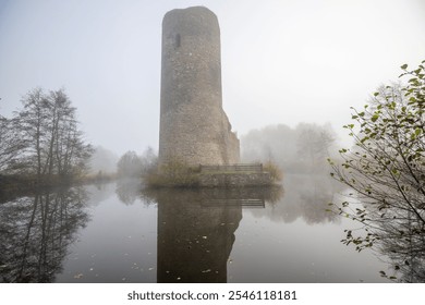 Ruins of a castle. Landscape shot in autumn. Defensive structure in a lake. Misty landscape in the morning at the historical sight in Morbach, Baldenau castle ruins, Rhineland-Palatinate, Germany - Powered by Shutterstock