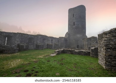 Ruins of a castle. Landscape shot in autumn. Defensive structure in a lake. Misty landscape in the morning at the historical sight in Morbach, Baldenau castle ruins, Rhineland-Palatinate, Germany - Powered by Shutterstock