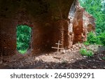 Ruins of Church of St. Peter and Paul in village of Vyshov, Mogilev region, Belarus. Wooden cross inside ruins
