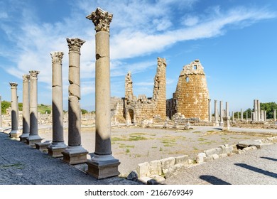 Ruins of colonnade and Hellenistic city gate in Perge at Antalya Province, Turkey. View of the ancient Greek city. Perge is a popular tourist destination in Turkey.