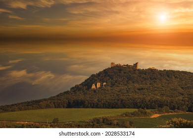 The ruins of the Devicky castle in the Palava region in South Moravia in the Czech Republic. There are clouds in the sky at sunset.