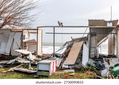 ruins and distructions cousea by a devastating typhoon on a sea coast. wreckage and wastes near sea shore. elimination of the damage and distructions caused by the hurricane to the coast