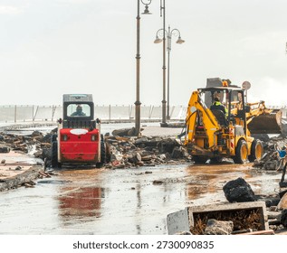 ruins and distructions cousea by a devastating typhoon on a sea coast. wreckage and wastes near sea shore. elimination of the damage and distructions caused by the hurricane to the coast