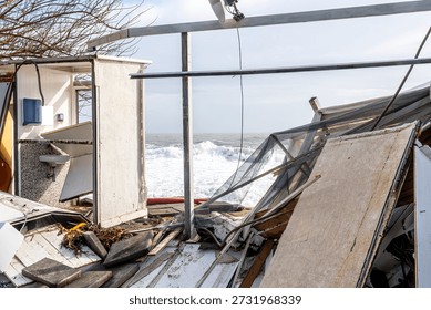 ruins and distructions cousea by a devastating typhoon on a sea coast. wreckage and wastes near sea shore. elimination of the damage and distructions caused by the hurricane to the coast