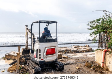 ruins and distructions cousea by a devastating typhoon on a sea coast. wreckage and wastes near sea shore. elimination of the damage and distructions caused by the hurricane to the coast