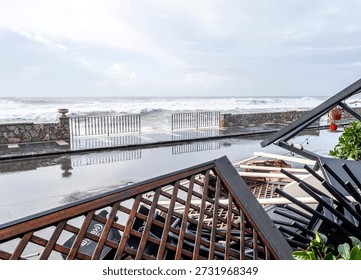 ruins and distructions cousea by a devastating typhoon on a sea coast. wreckage and wastes near sea shore. elimination of the damage and distructions caused by the hurricane to the coast