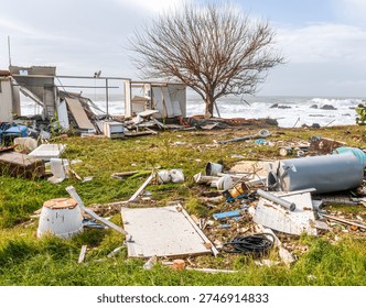 ruins and distructions cousea by a devastating typhoon on a sea coast. wreckage and wastes near sea shore. elimination of the damage and distructions caused by the hurricane to the coast