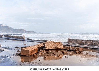 ruins and distructions cousea by a devastating typhoon on a sea coast. wreckage and wastes near sea shore. elimination of the damage and distructions caused by the hurricane to the coast