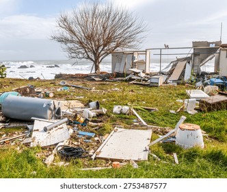 ruins and distructions cousea by a devastating typhoon on a sea coast. wreckage and wastes near sea shore. elimination of the damage and distructions caused by the hurricane to the coast