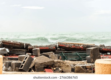 ruins and distructions cousea by a devastating typhoon on a sea coast. wreckage and wastes near sea shore. elimination of the damage and distructions caused by the hurricane to the coast