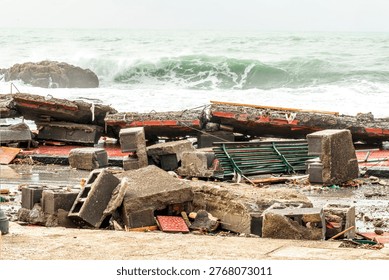 ruins and distructions cousea by a devastating typhoon on a sea coast. wreckage and wastes near sea shore. elimination of the damage and distructions caused by the hurricane to the coast