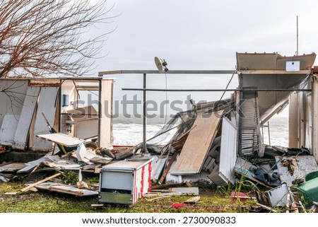ruins and distructions cousea by a devastating typhoon on a sea coast. wreckage and wastes near sea shore. elimination of the damage and distructions caused by the hurricane to the coast