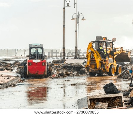 ruins and distructions cousea by a devastating typhoon on a sea coast. wreckage and wastes near sea shore. elimination of the damage and distructions caused by the hurricane to the coast