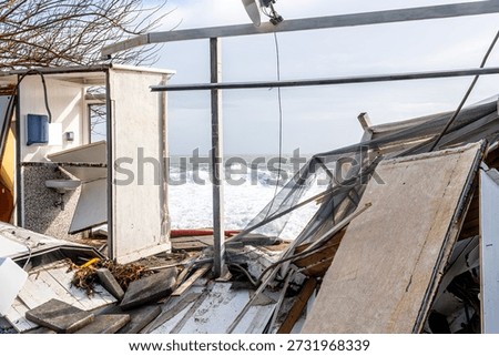 ruins and distructions cousea by a devastating typhoon on a sea coast. wreckage and wastes near sea shore. elimination of the damage and distructions caused by the hurricane to the coast