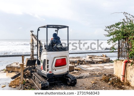 ruins and distructions cousea by a devastating typhoon on a sea coast. wreckage and wastes near sea shore. elimination of the damage and distructions caused by the hurricane to the coast