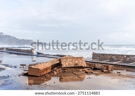 ruins and distructions cousea by a devastating typhoon on a sea coast. wreckage and wastes near sea shore. elimination of the damage and distructions caused by the hurricane to the coast