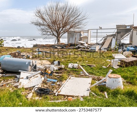 ruins and distructions cousea by a devastating typhoon on a sea coast. wreckage and wastes near sea shore. elimination of the damage and distructions caused by the hurricane to the coast