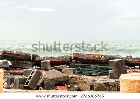ruins and distructions cousea by a devastating typhoon on a sea coast. wreckage and wastes near sea shore. elimination of the damage and distructions caused by the hurricane to the coast