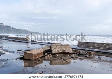 ruins and distructions cousea by a devastating typhoon on a sea coast. wreckage and wastes near sea shore. elimination of the damage and distructions caused by the hurricane to the coast